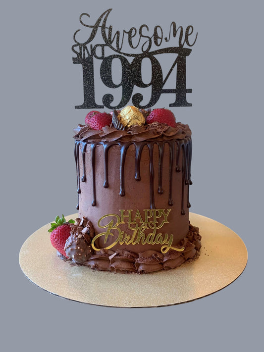 Sarah's Cakes chocolate drip birthday cake with 'Awesome Since 1994' topper and fresh strawberries.