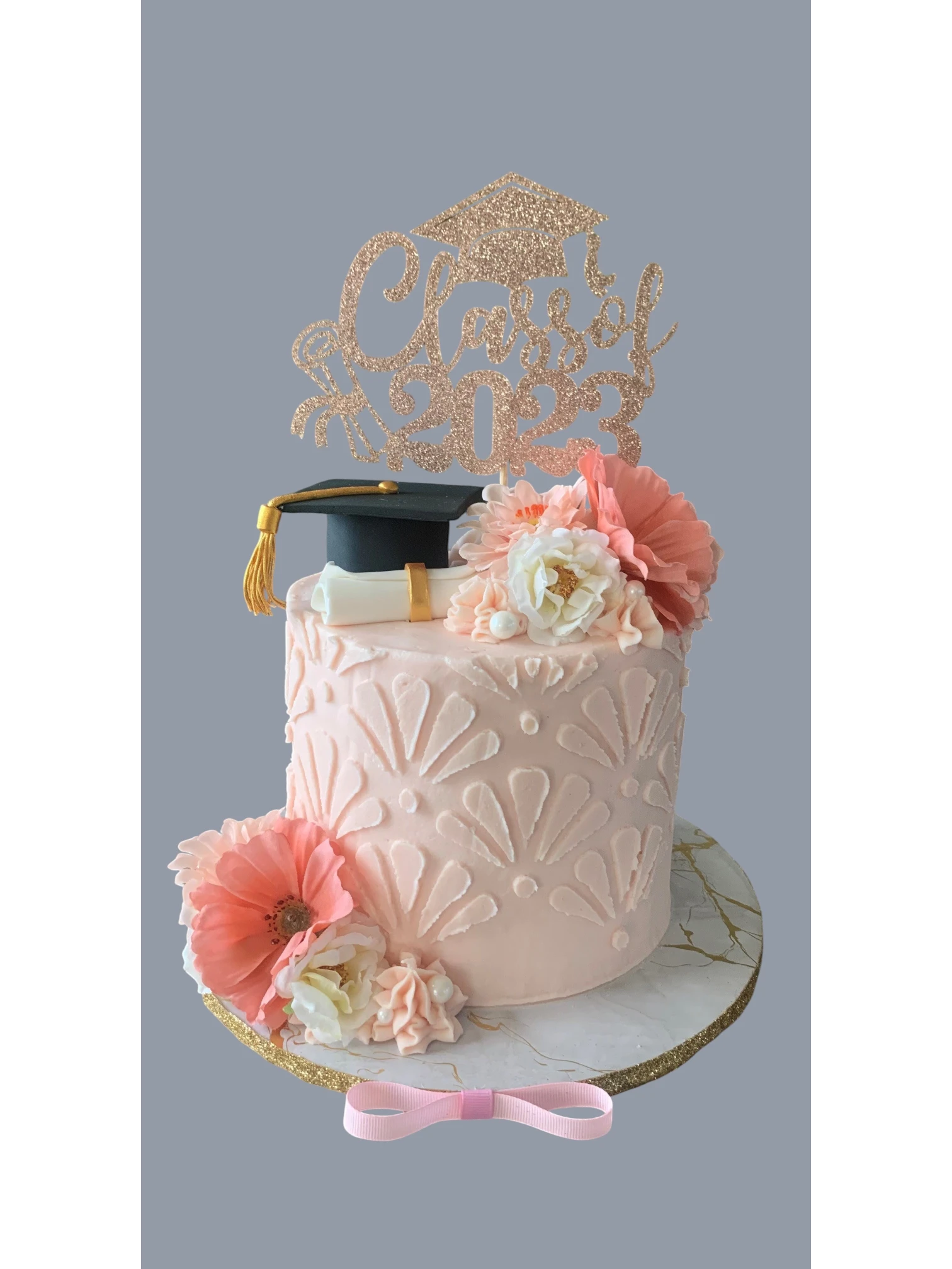 Sarah's Cakes graduation cake with 'Class of 2023' topper, diploma, and mortarboard.
