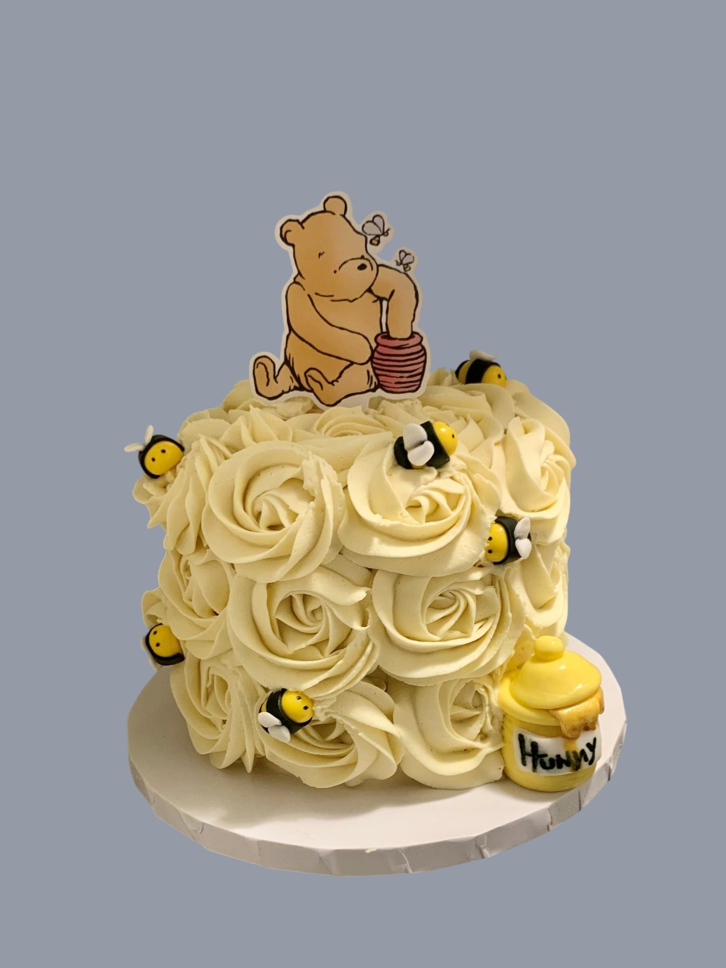 Sarah's Cakes 5in smash cake with vanilla buttercream frosting, Winnie the Pooh topper, and fondant bees.